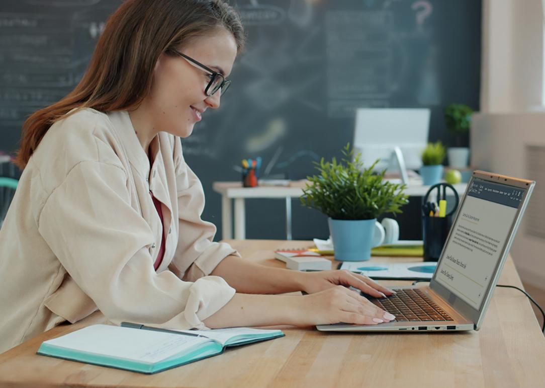 A teacher working at a computer